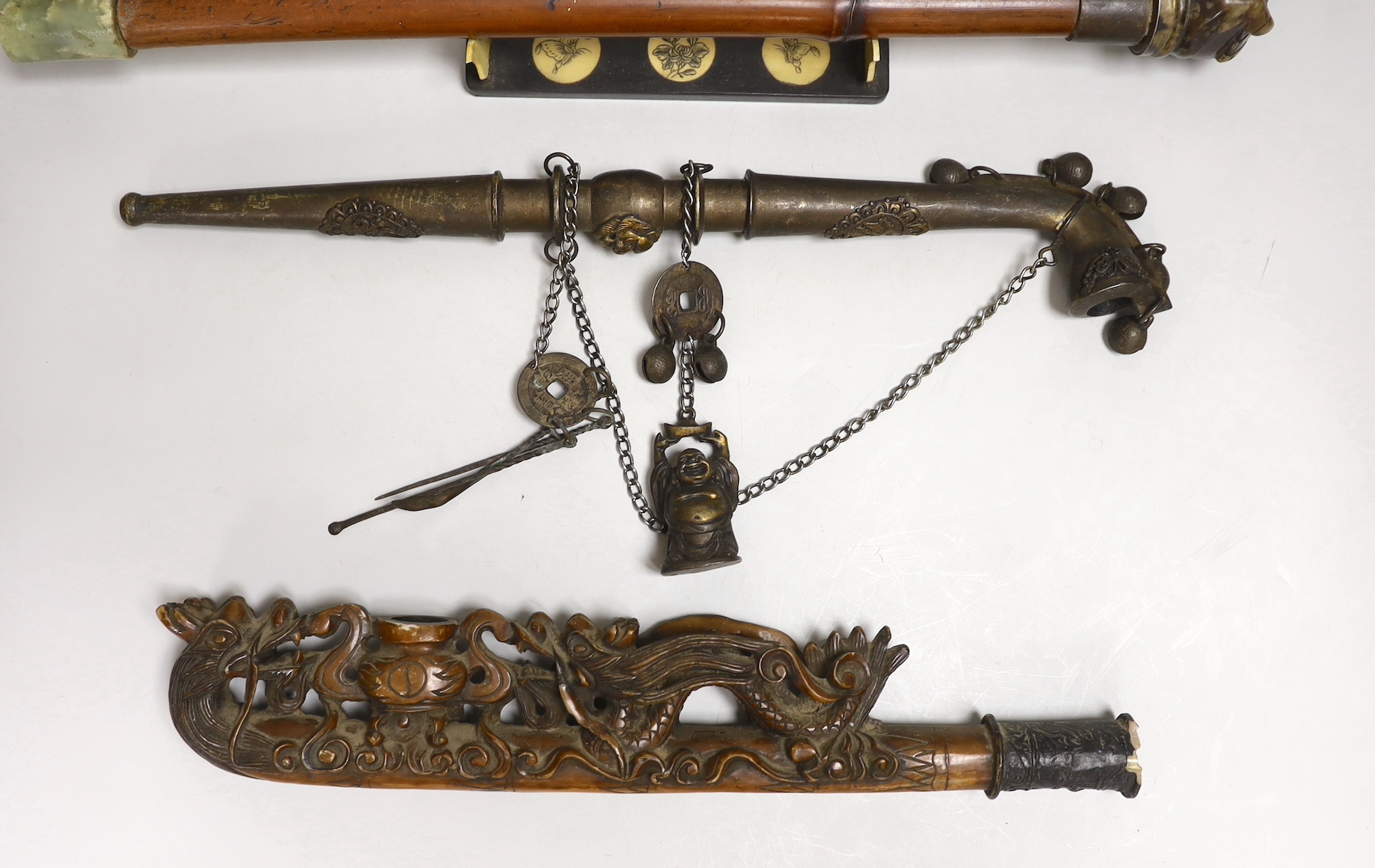 A collection of four Chinese or Indonesian opium pipes, 41.5cm long